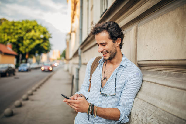 istock Handsome man using smart phone on the street 1166976391