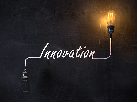 Innovation concept on blackboard with glowing lightbulb. ( 3d render )