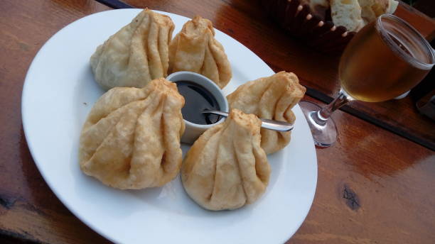 istock Fried khinkali and a glass of white wine 1166976596