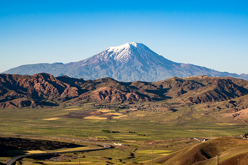 Igdir, Turkey, Middle East - July 01, 2019: breathtaking view of Mount Ararat, Agri Dagi, the highest mountain in the extreme east of Turkey accepted in Christianity as the resting place of Noah's Ark, a snow-capped and dormant compound volcano