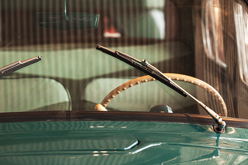 Windshield wiper and steering wheel. Old timer car details. Close up photo with soft selective focus