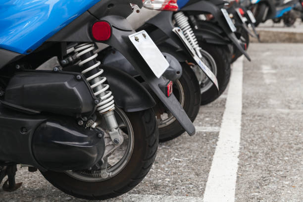 istock Modern city scooters stand in a row 1166977401