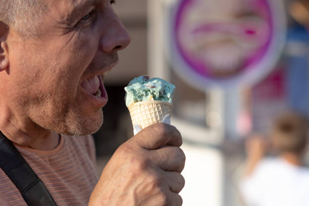 istock A middle age man eating ice cream on the street. 1166977425