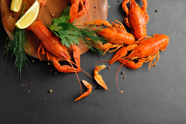 istock lobster with lemon lime and dry pepper on black background top view 1166978028