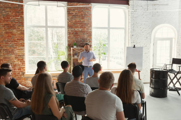 istock Male speaker giving presentation in hall at university workshop 1166978135