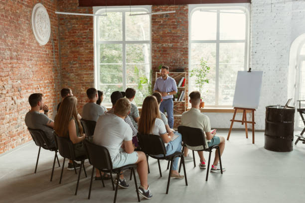 istock Male speaker giving presentation in hall at university workshop 1166978771