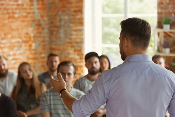 istock Male speaker giving presentation in hall at university workshop 1166978780