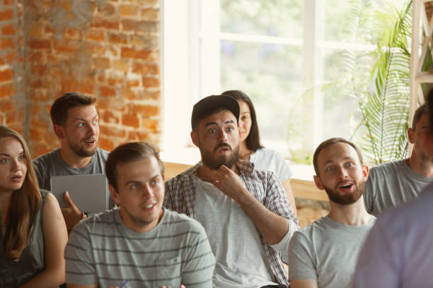 istock Students listening to presentation in hall at university workshop 1166978802