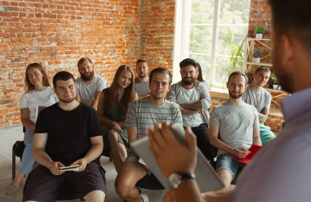 istock Male speaker giving presentation in hall at university workshop 1166978840