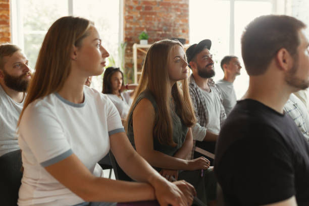 istock Students listening to presentation in hall at university workshop 1166978969