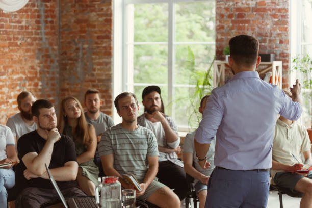 istock Male speaker giving presentation in hall at university workshop 1166978971