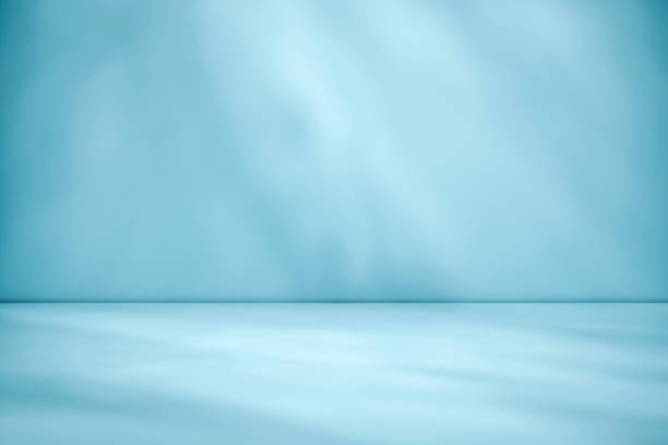 istock Beams of sunlight on a blue green background 1166982236
