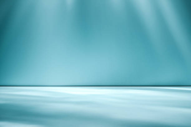 istock Beams of sunlight on a blue green background 1166982253