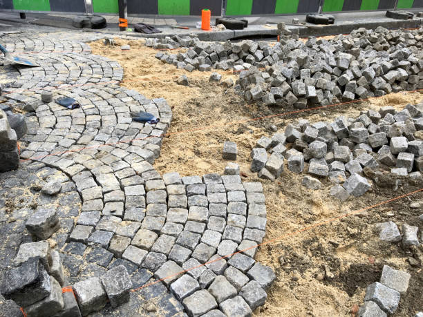 istock Street under construction, laying pavers_3 1166983398