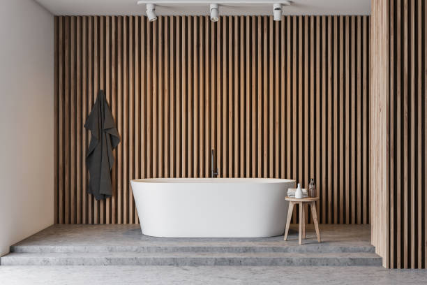 istock Light wooden bathroom interior with tub 1166983409