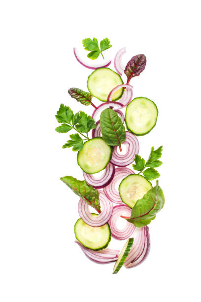 istock Flying Vegetables - cucumber, onions, parsley and chard 1166983529