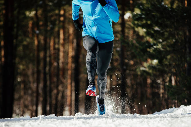 istock athlete runner running in winter trail 1166985819