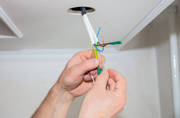 istock Man is making electrical insulator. Light bulb wires with adhesive tape. Maintenance repair works in the flat. Restoration indoors. 1166988660