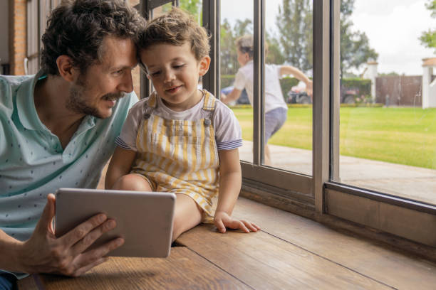 istock Father and sons with digital tablet 1166990622