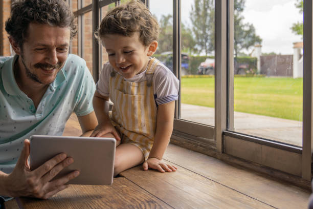 istock Father and sons with digital tablet 1166990647