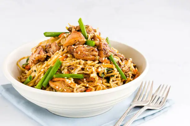 Chicken Chow Mein in a White Bowl with Forks. Chinese Food / Asian Food Photography.