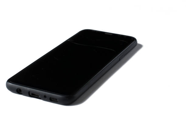 istock Black phone with a cracked screen isolated on a white background. 1166991636