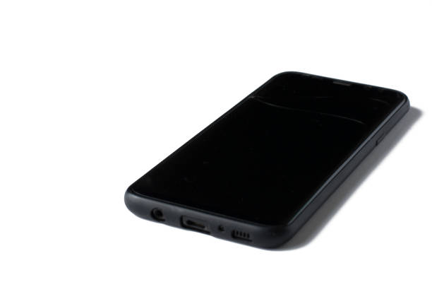 istock Black phone with a cracked screen isolated on a white background. 1166991704