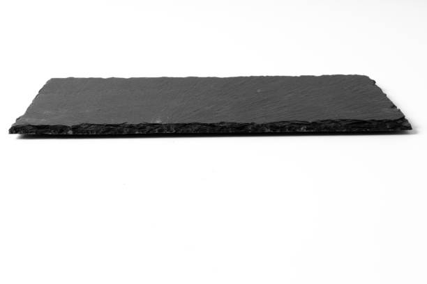 istock Black stone plate isolated on white background 1166991958