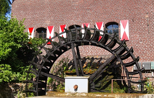 Brüggen, Germany - August 8. 2019: View on medieval watermill with paddle wheel in small german village