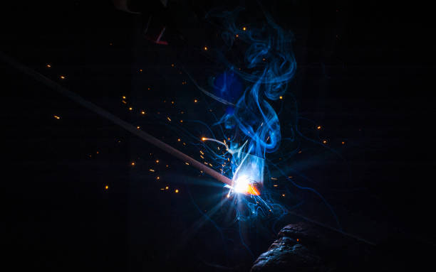 istock Worker with protective gloves welding metal part in workshop. 1166995469