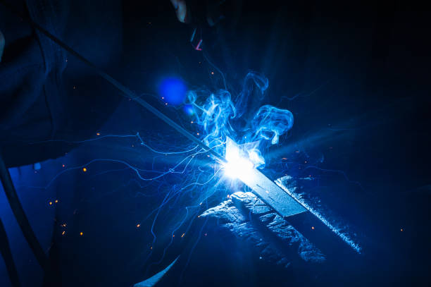 istock Worker with protective gloves welding metal part in workshop. 1166995513