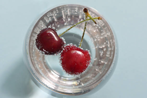 istock Glass of water and fresh cherries with bubbles 1166995584