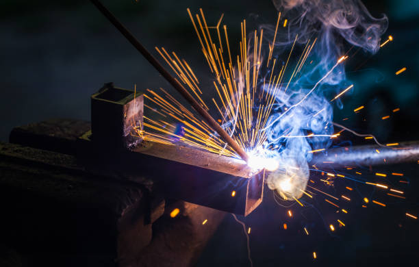 istock Worker with protective gloves welding metal part in workshop. 1166995598