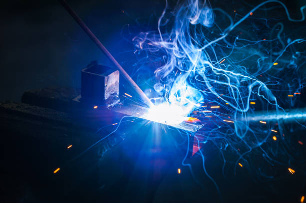 istock Worker with protective gloves welding metal part in workshop. 1166995619