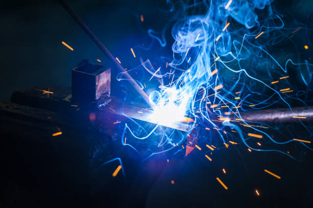 istock Worker with protective gloves welding metal part in workshop. 1166995716