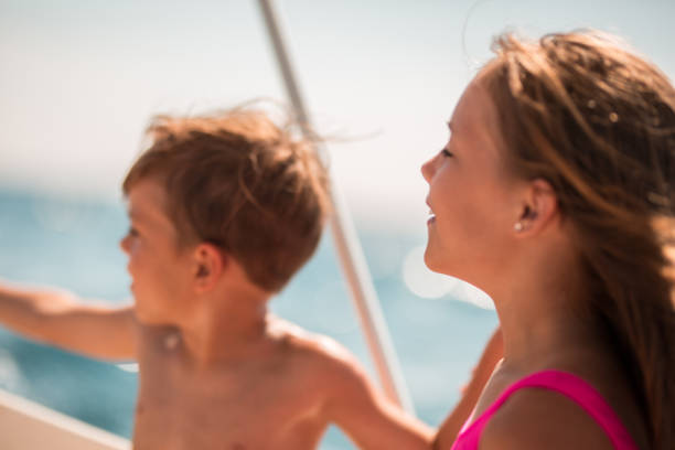 Children on nautical vessel looking at horizon