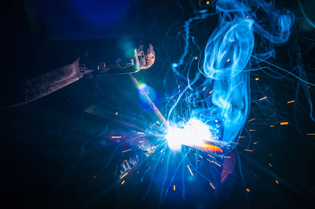 istock Worker with protective gloves welding metal part in workshop. 1166995806