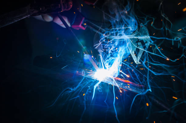 istock Worker with protective gloves welding metal part in workshop. 1166995969