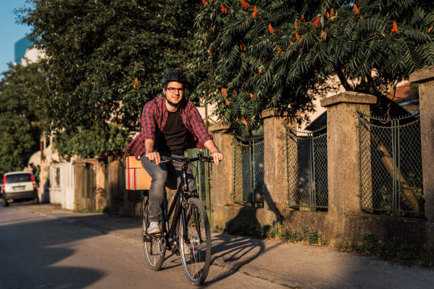 istock Delivery boy riding bicycle in the city 1166996935
