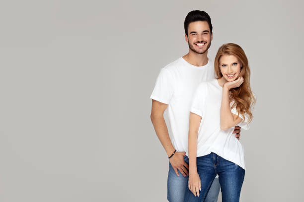 istock Happy youg couple posing together in studio. 1166997243