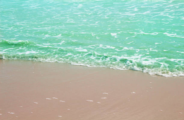 istock Waves breaking on sandy shore , Landscape nature sea background 1166997931