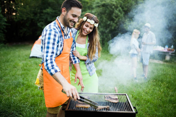 istock Handsome male preparing barbecue outdoors for friends 1166999719