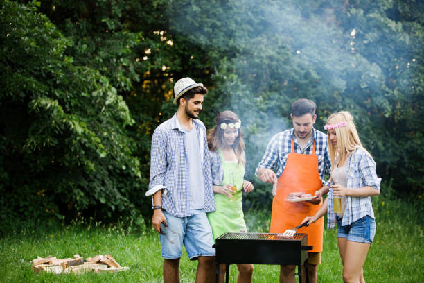 istock Group of happy people standing around grill, chatting, drinking and eating. 1167002053