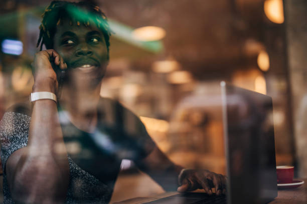 istock Black gentleman talking on mobile in cafe 1167002590