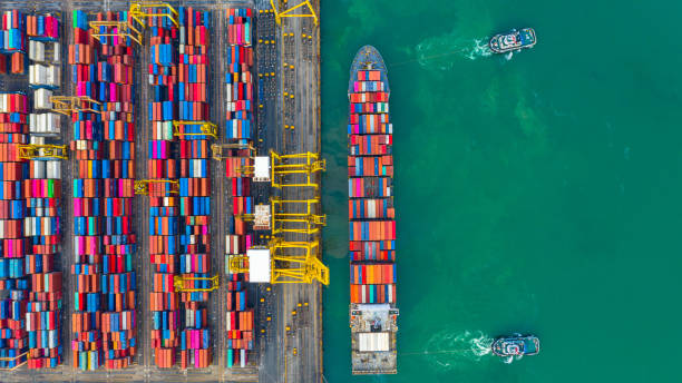 istock Container ship working at industrial port, Business import and export logistic and transportation of International by container ship in the open sea, Aerial view container ship loading and unloading. 1167003267