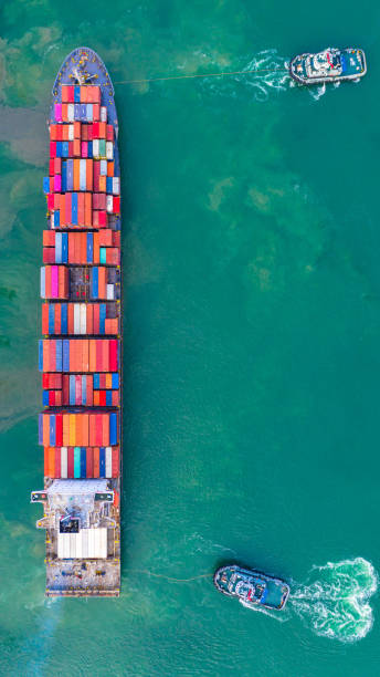 istock Container ship working at industrial port, Business import and export logistic and transportation of International by container ship in the open sea, Aerial view container ship loading and unloading. 1167003279