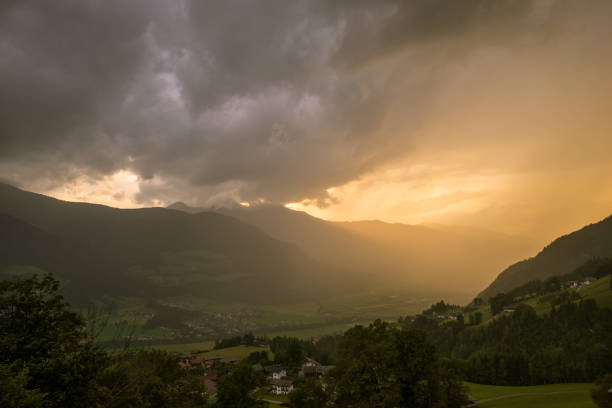 Ominous sky as a thunderstorm travels through a valley in the Alps, Europe.