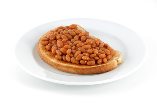 plate of beans on toast isolated on white