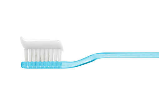 white toothpaste on blue toothbrush isolated isolated on white with clipping path