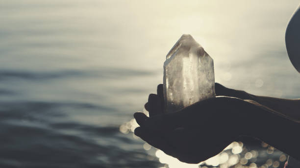 Beach relaxation. Holding healing crystals